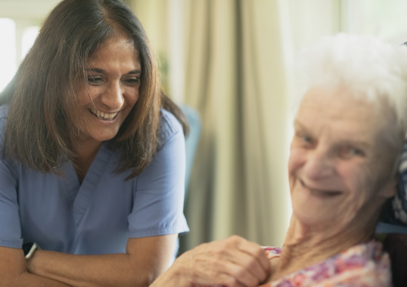 A warm conversation between a caregiver and an assisted living resident.
