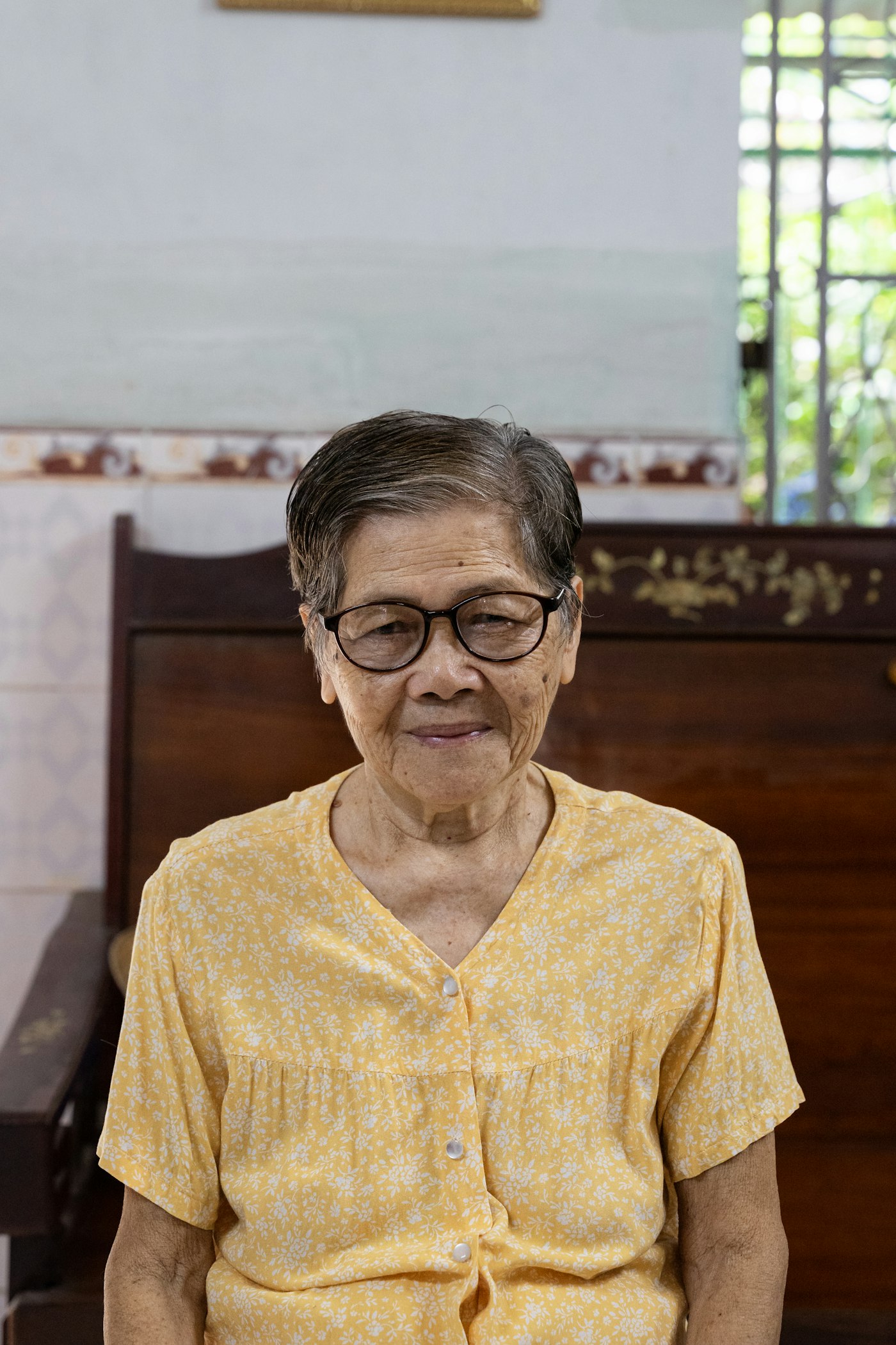 An older adult resting quietly, thoughtful and serene.