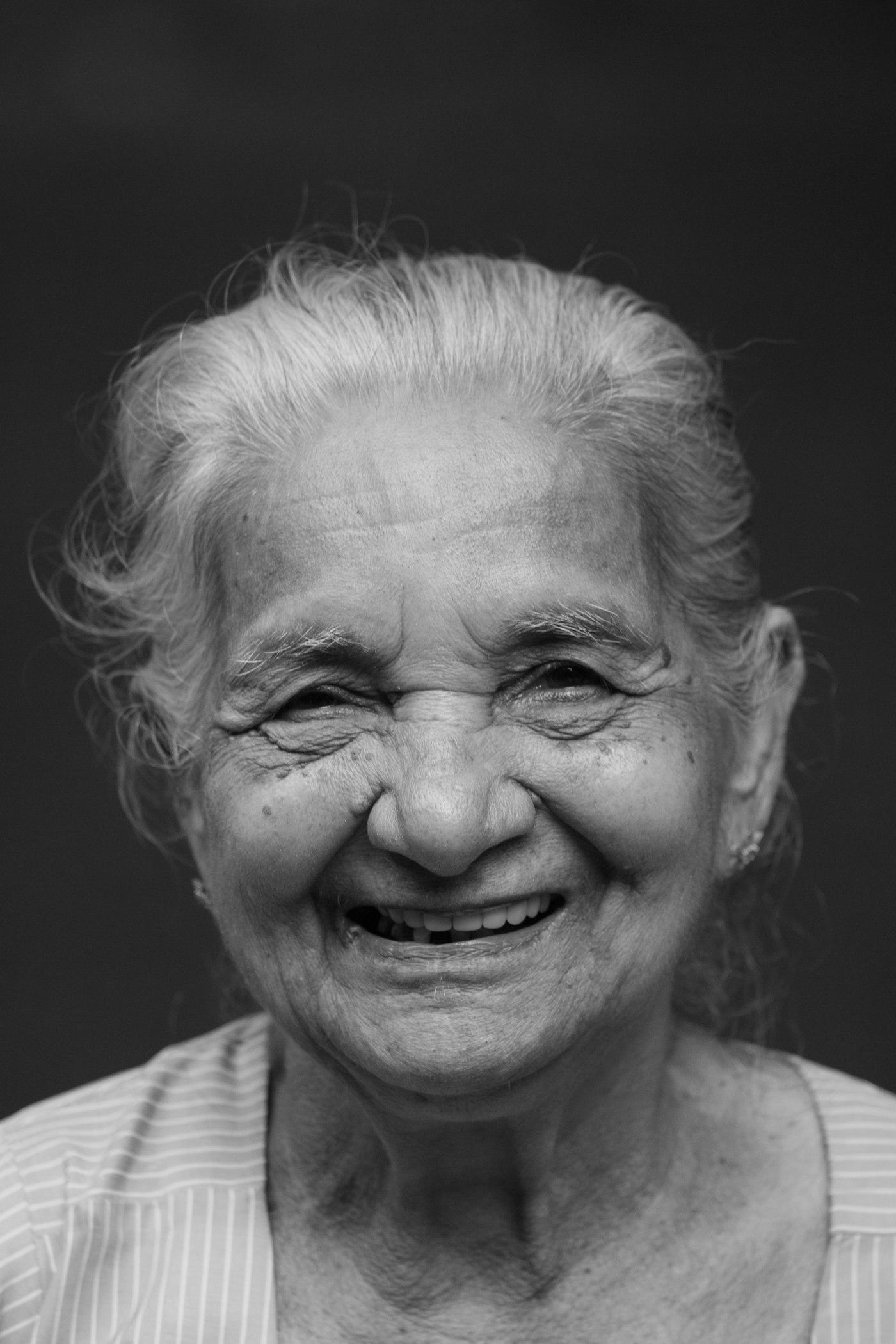 An older adult laughing, full of life and good spirits.
